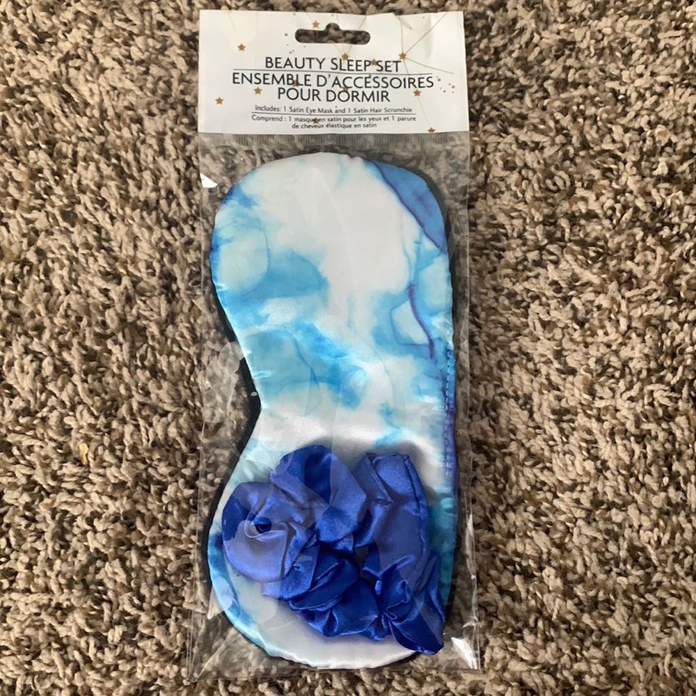 Blue satin eye mask and hair scrunchie. Never used, still in packaging.